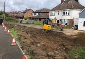 Driveway excavation underway with a mini digger