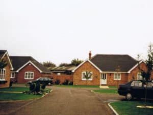Estate road leading to a cul-de-sac of bungalows