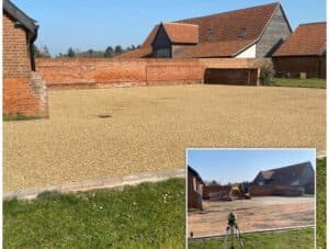 Golden tar-and-chip yard in front of barns