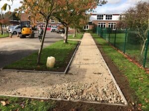 Footpath being prepared alongside a school fence