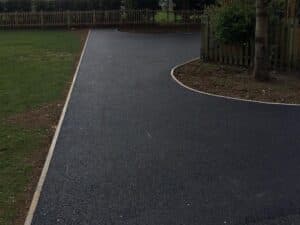 Curved tarmac footpath edged with timber