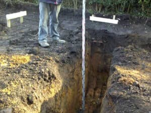 Excavated trench marked out with profile boards
