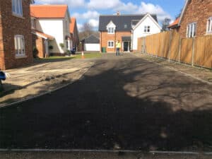 Newly surfaced estate road between new-build houses
