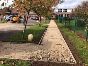 Footpath sub-base preparation beside a fence
