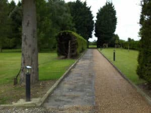 Tree-lined estate drive with gravel and tar-and-chip strips