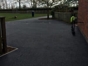 Tarmac path and yard beside a residential building